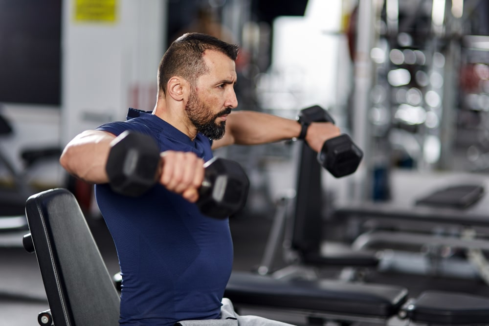 Man Doing Shoulder Workout With Dumbbells