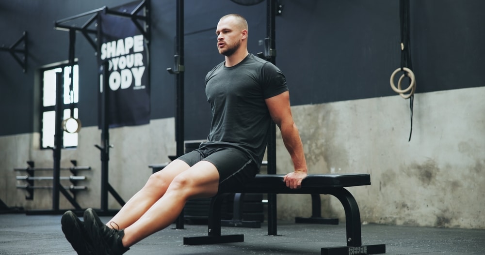 Gym Bench And Man With Dips Workout For Body Building