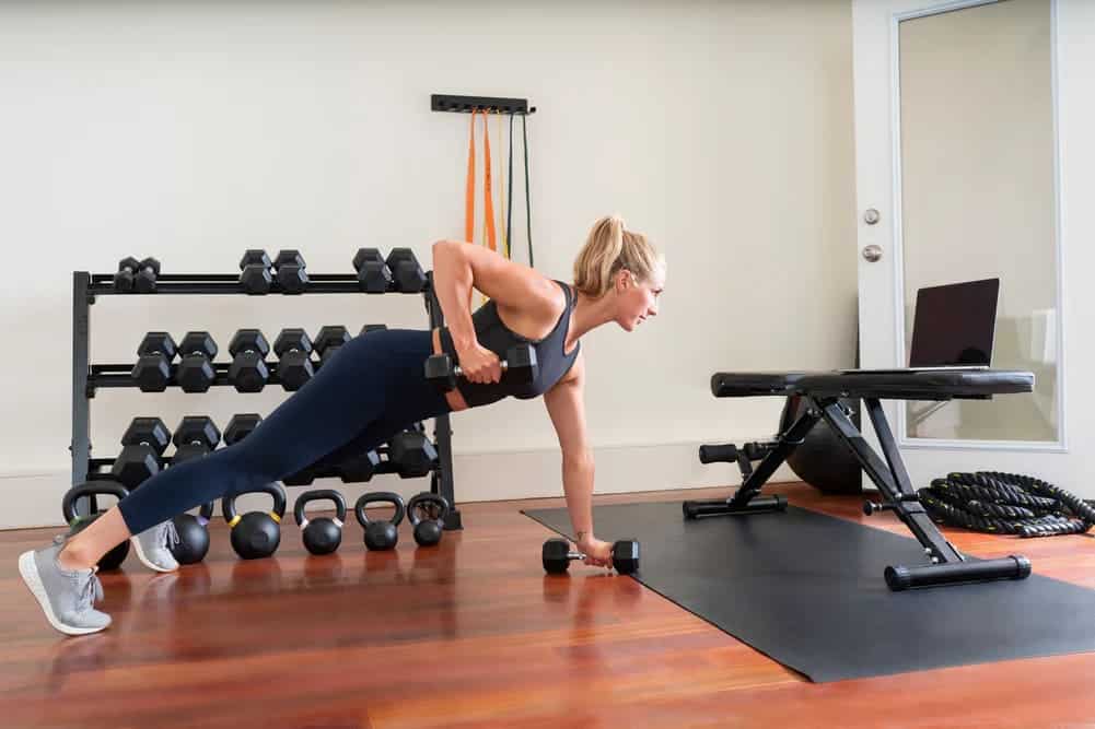 a women doing tricep exercise with dumbell