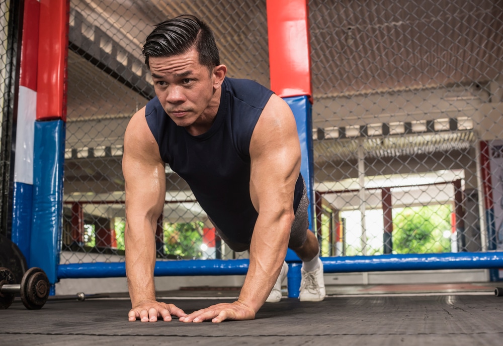 A Fit Asian Man Does Diamond Push Ups At A