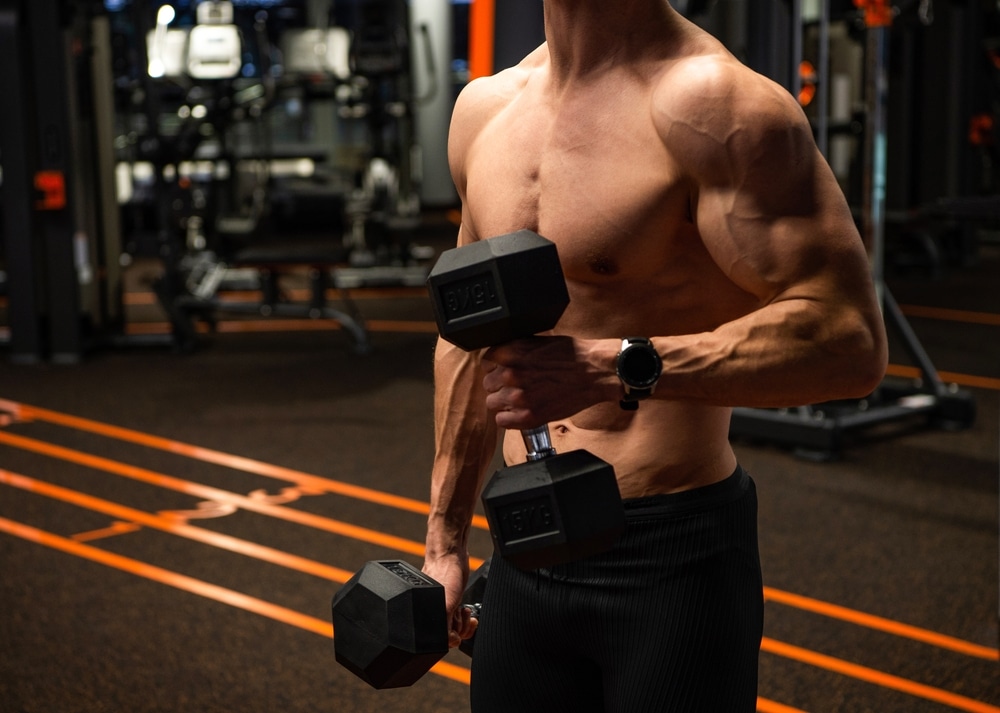 Shirtless Man Crop View Doing Bicep Tricep Curls With Dumbbells