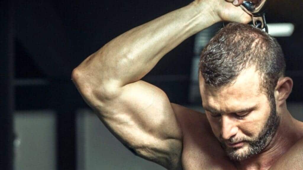 man doing single arm tricep exercise 