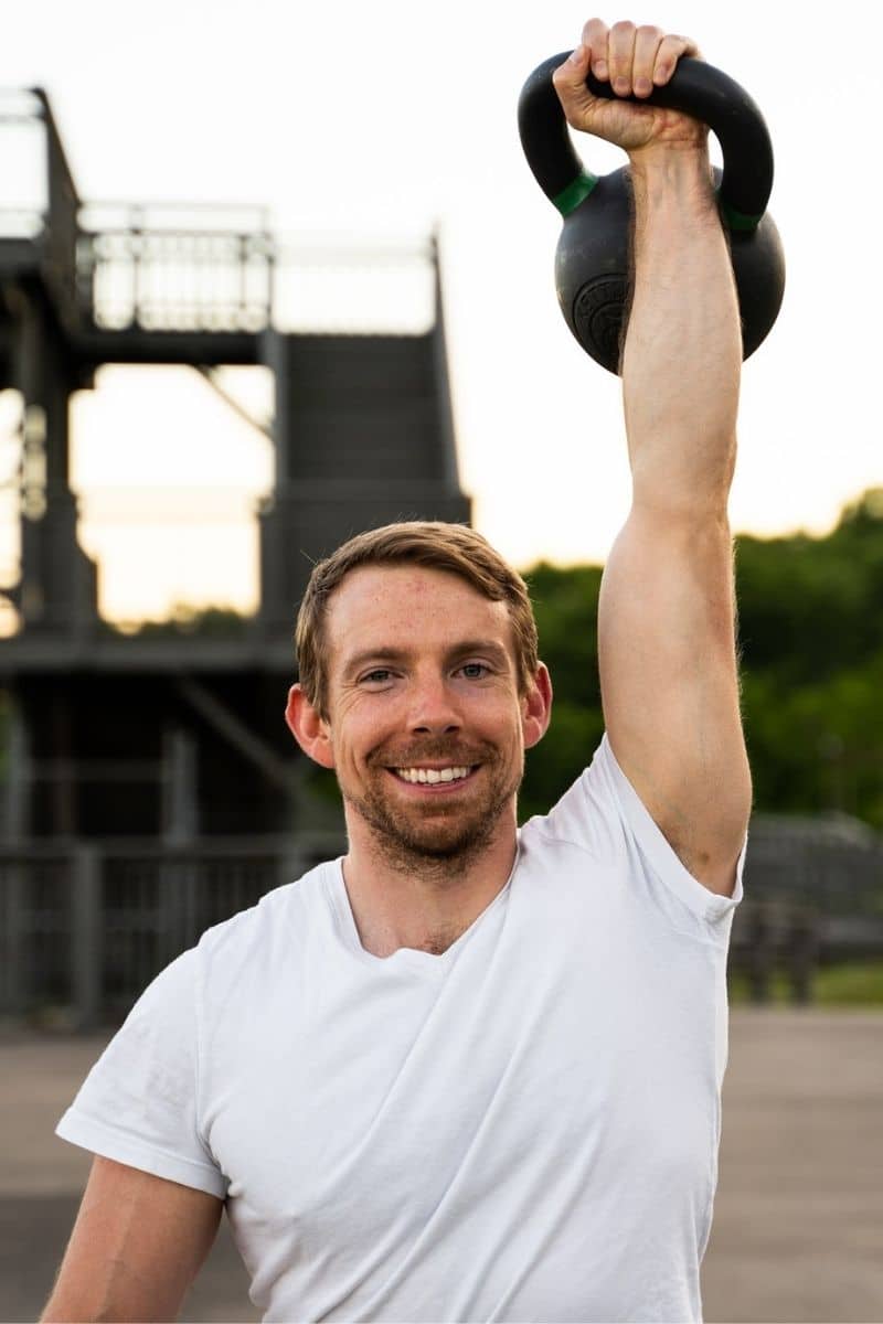 a person is doing kettlebell press for triceps