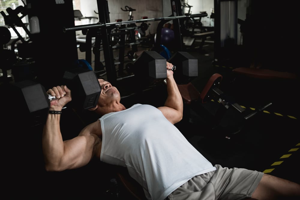 A Fit Asian Guy In A White Tank Top Does