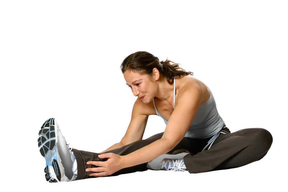 Female Fitness Trainer Doing Stretching For Her Calf And Back