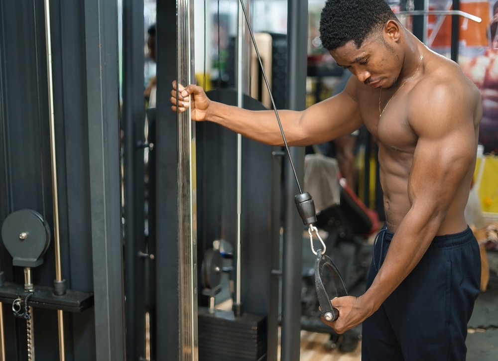 Arm Strength And Power: A Young Shirtless Muscular Man Exercising